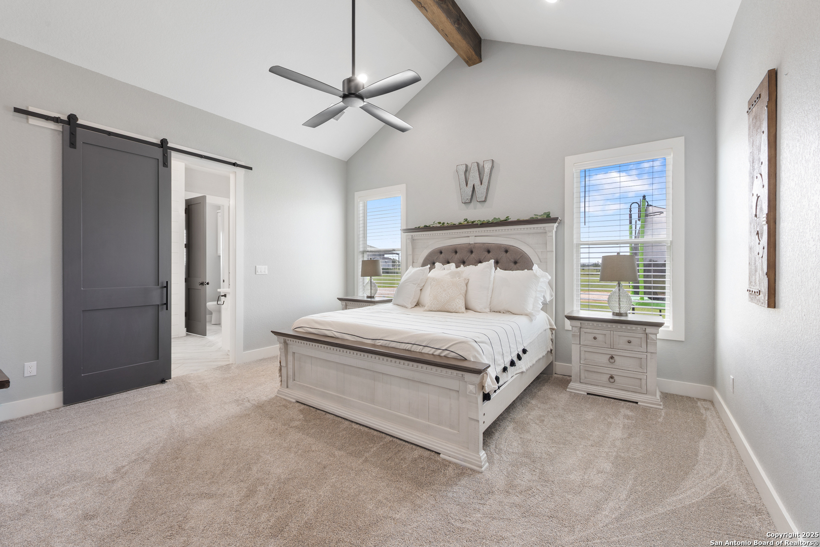 32139 Giboney Road Hempstead, TX 77445 - Photo 22 of 65 a bedroom with a large bed and a chandelier