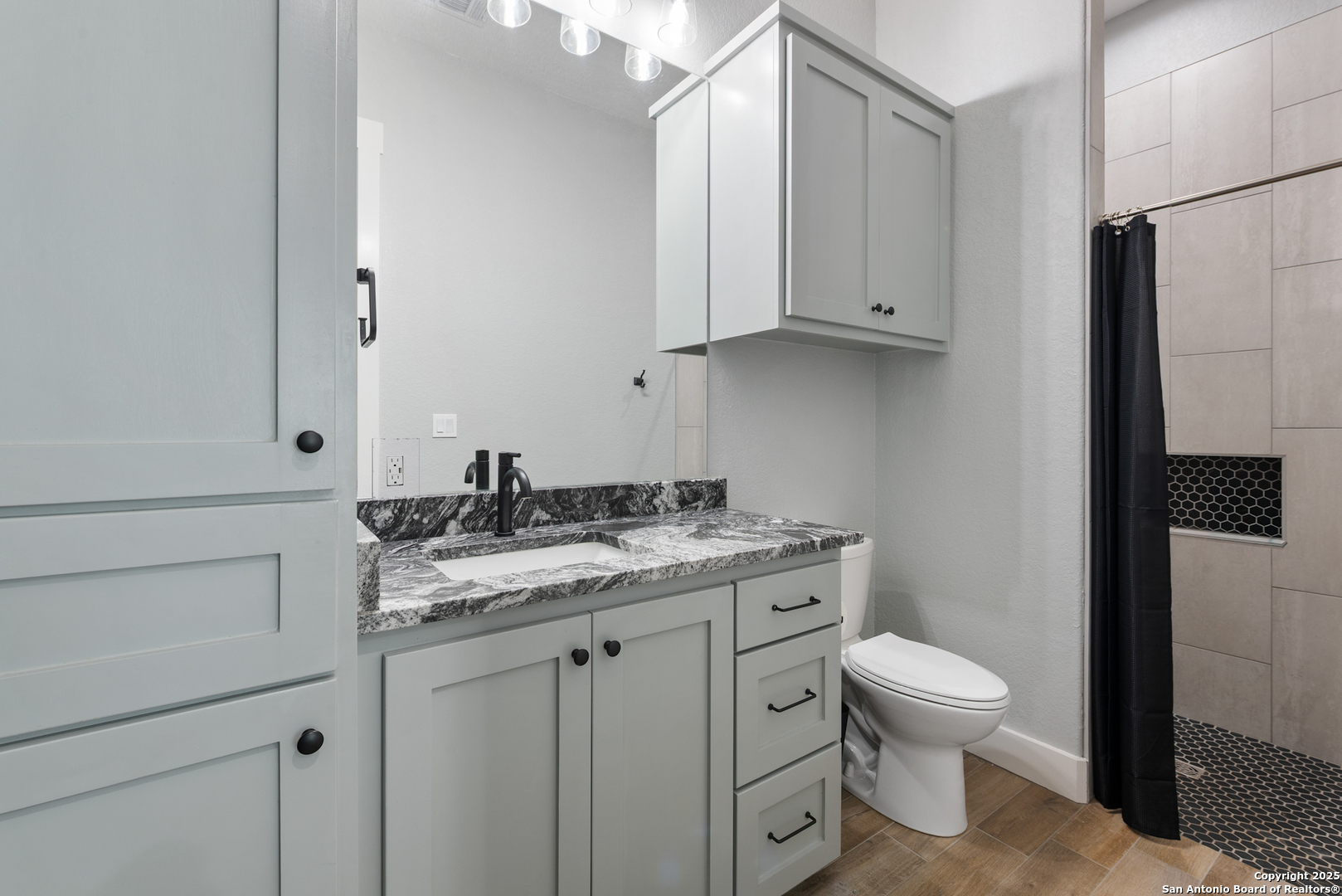 32139 Giboney Road Hempstead, TX 77445 - Photo 39 of 65 a bathroom with a granite countertop toilet sink and mirror