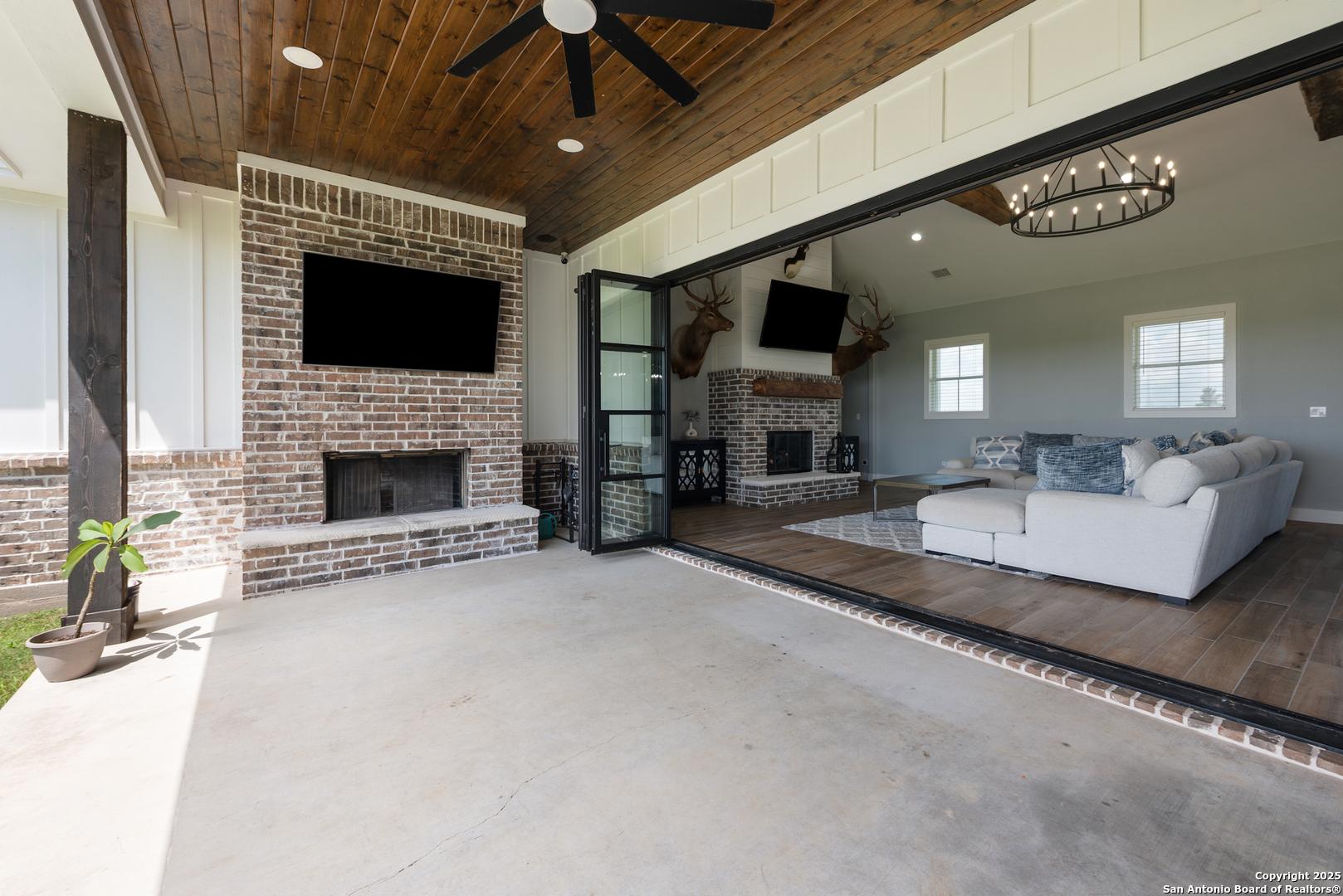 32139 Giboney Road Hempstead, TX 77445 - Photo 53 of 65 a living room with furniture a flat screen tv and a fireplace