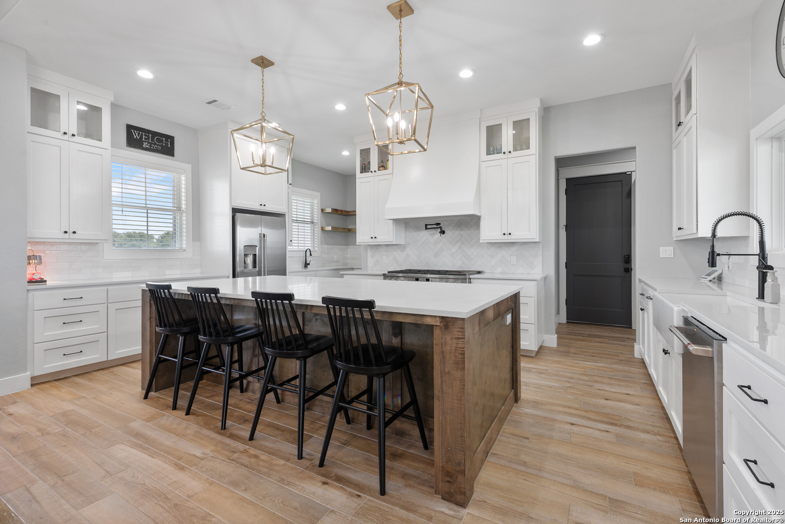 32139 Giboney Road Hempstead, TX 77445 - Photo 8 of 65 a large kitchen with cabinets chairs and wooden floor