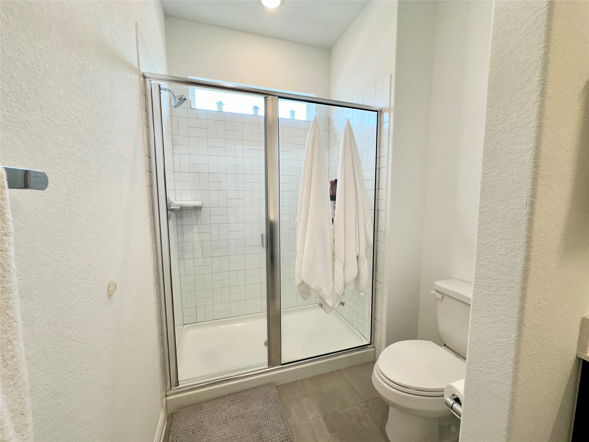2009 Winston Way Leander, TX 78641 - Photo 16 of 21 a bathroom with a granite countertop toilet a sink and shower