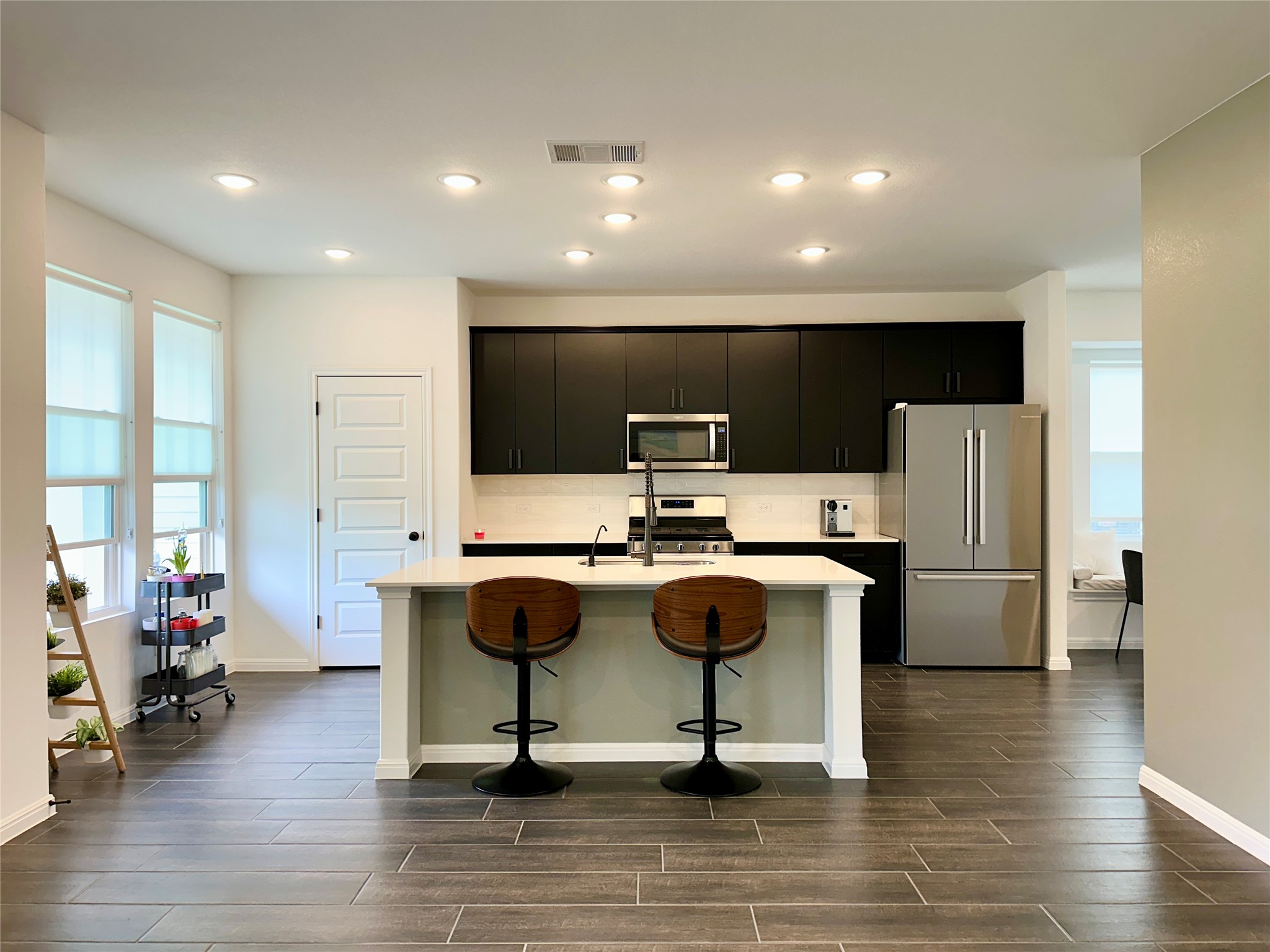 2009 Winston Way Leander, TX 78641 - Photo 3 of 21 a view of kitchen with stainless steel appliances kitchen island granite countertop a stove and a refrigerator