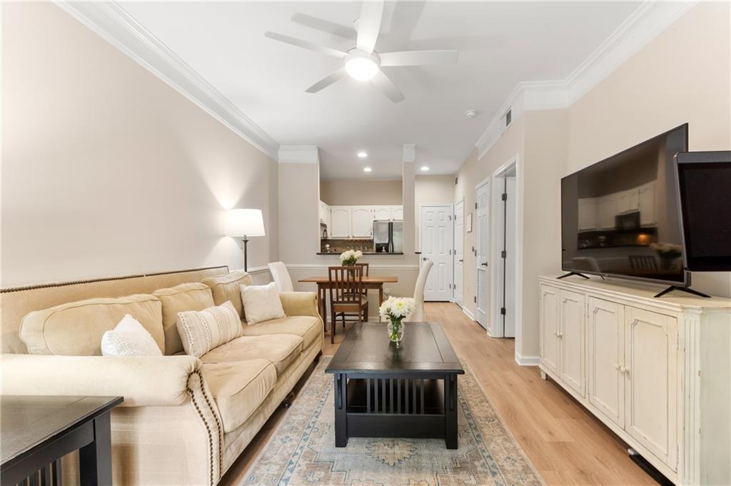 2700 Pine Tree Road Northeast, Unit 4005 Atlanta, GA 30324 - Photo 1 of 1 a living room with furniture and a flat screen tv