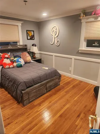 a bedroom with a bed and paintings on the wall