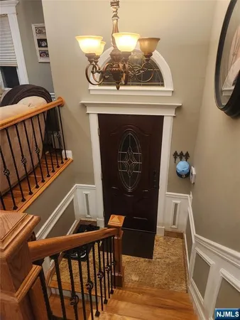 a view of a hardwood floor and an entryway