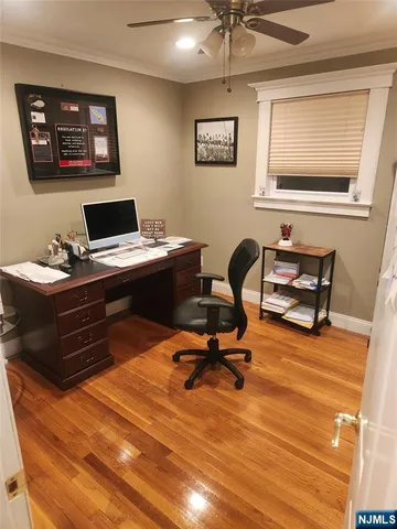 a view of a workspace with furniture and a window