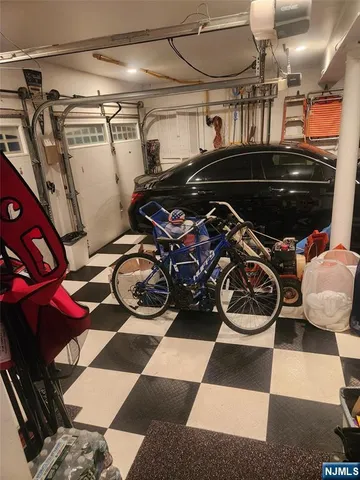 a view of a room with water heater and racks on the wall