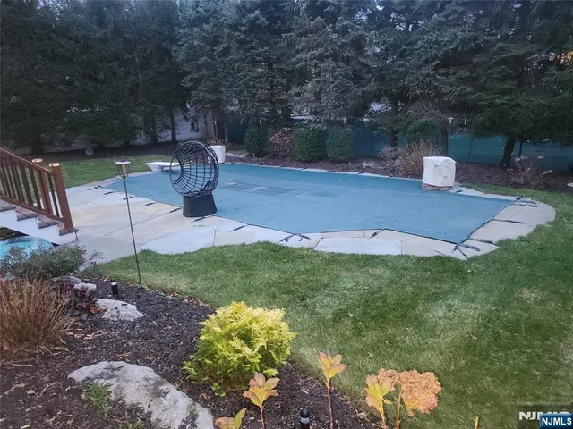 a backyard of a house with table and chairs