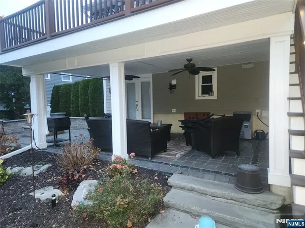 a view of a patio with table and chairs and potted plants