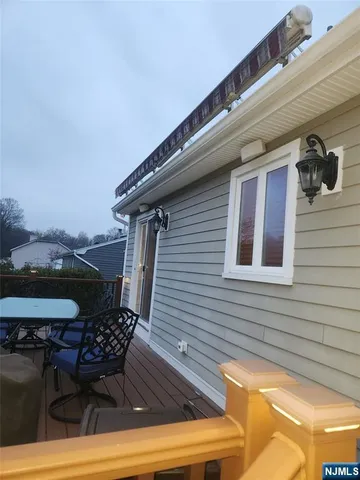 a couple of chairs sitting in a balcony