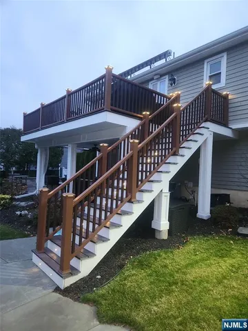 a view of a house with backyard and deck