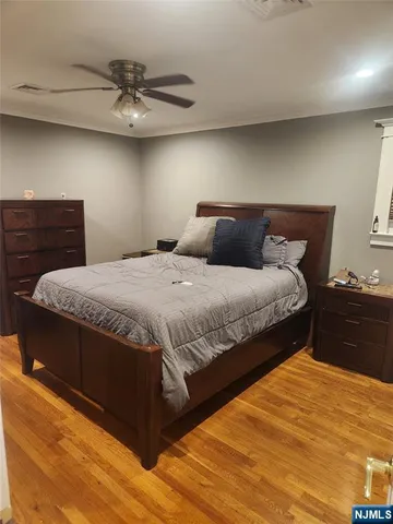 a bedroom with a bed and ceiling fan