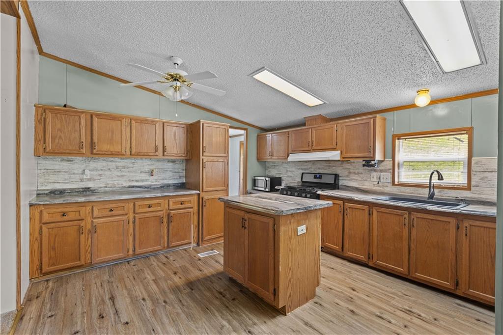 610 Pleasant Valley Road Washington, PA 15301 - Photo 15 of 27 a kitchen with stainless steel appliances granite countertop wooden cabinets granite counter tops and a hard wood floors