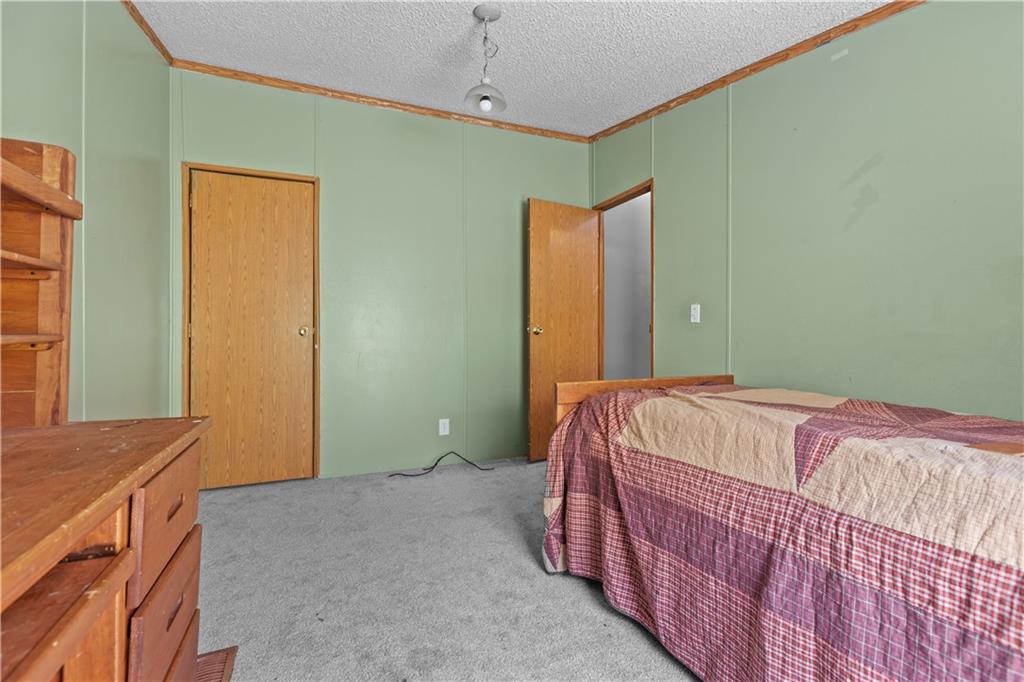 610 Pleasant Valley Road Washington, PA 15301 - Photo 22 of 27 a bed sitting in a bedroom next to a window