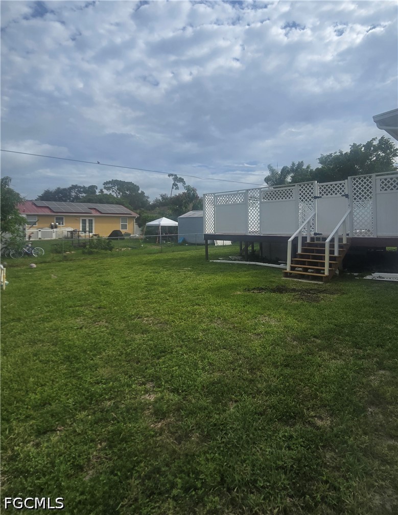 8093 Anhinga Road Fort Myers, FL 33967 - Photo 48 of 49 a view of a green field with house in the background