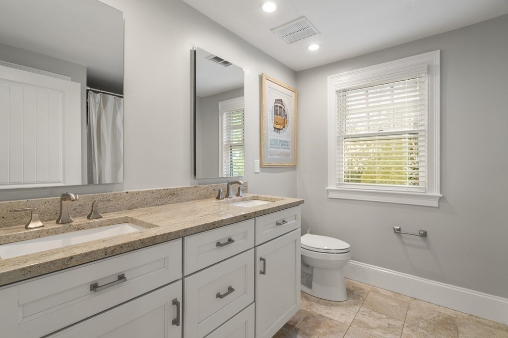 15 Old Town Road Wellesley, MA 02481 - Photo 25 of 30 a bathroom with a granite countertop toilet a sink a mirror a window and a shower