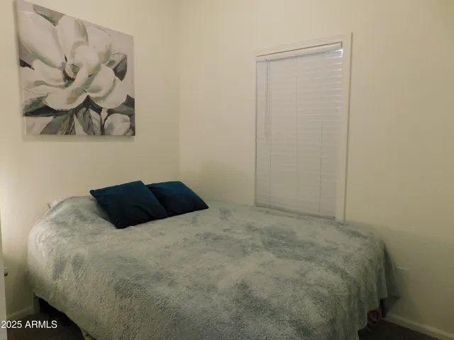 a bedroom with a bed and wall painting