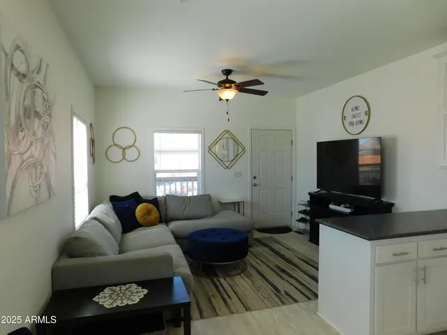 a living room with furniture a rug and a window