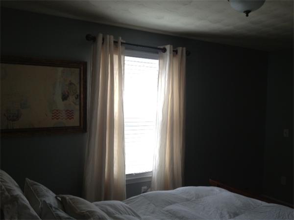 254 Shawmut Street Springfield, MA 01108 - Photo 5 of 21 a bed sitting in a bedroom next to a window