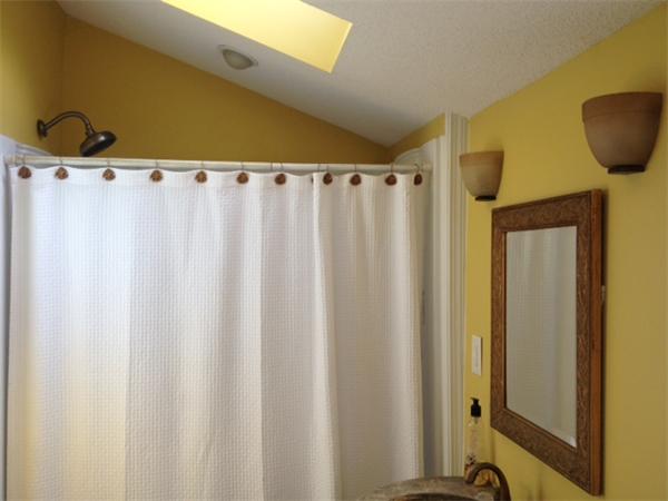 254 Shawmut Street Springfield, MA 01108 - Photo 7 of 21 a view of a bathroom with a shower curtain and a sink