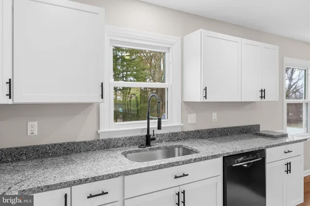a large kitchen with stainless steel appliances granite countertop a stove and a refrigerator