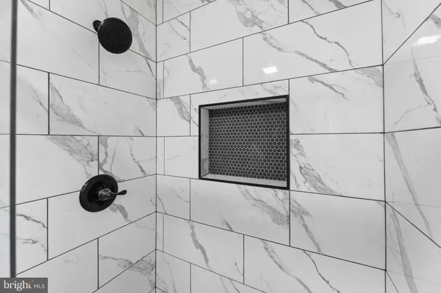 a bedroom with a bed table and a potted plant