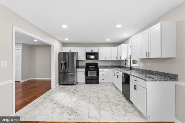 a kitchen with a refrigerator stove and sink