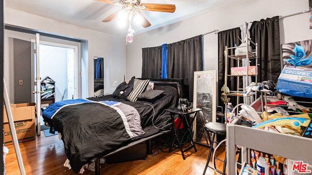 a bedroom with a bed and a bookshelf