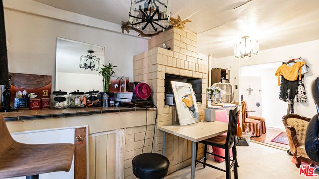 a view of a dining room with furniture and chandelier
