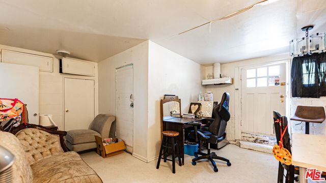 a view of a workspace with furniture and a window