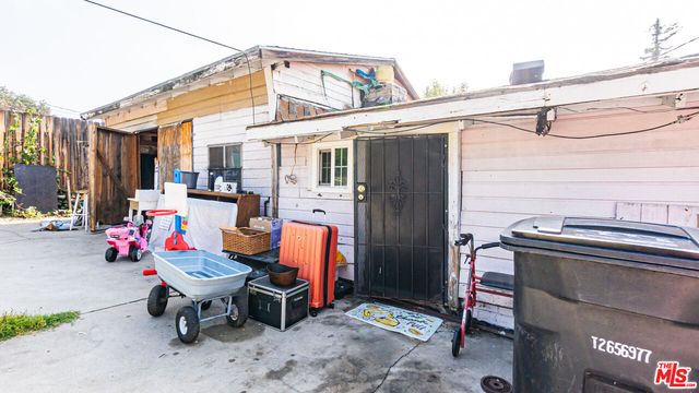 a backyard of a house with outdoor seating