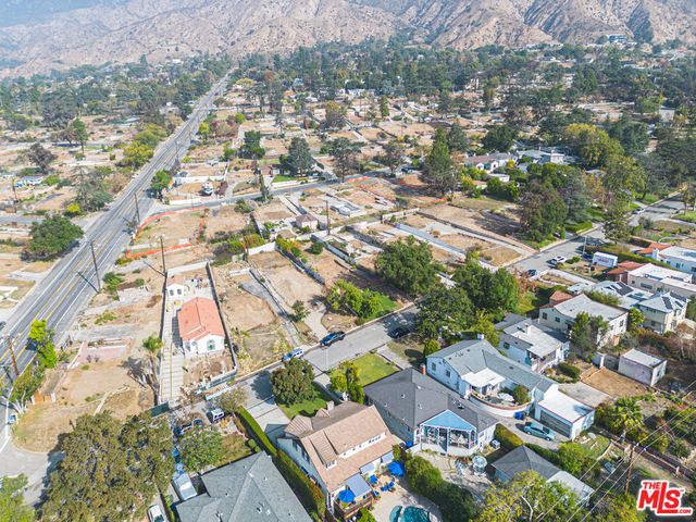 an aerial view of houses with yard