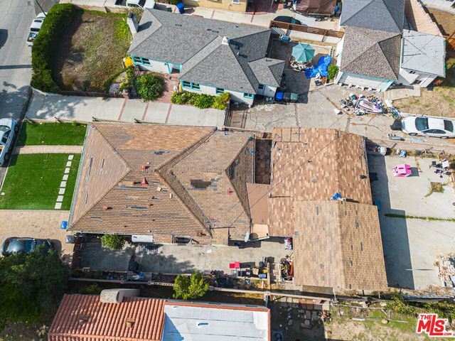 an aerial view of multiple houses with yard
