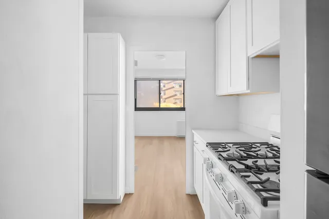 a kitchen with a stove and a refrigerator