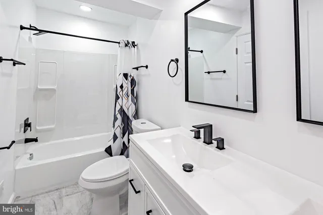 a bathroom with a sink a toilet and a bathtub