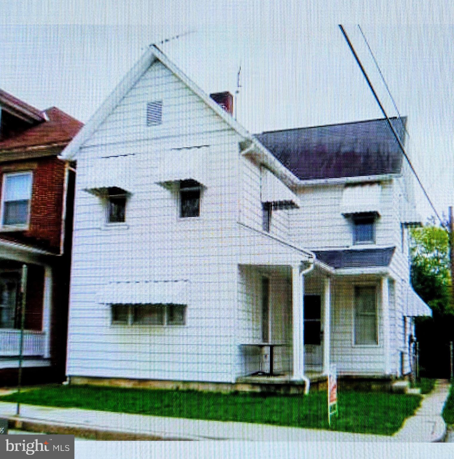213 Locust Street Hanover, PA 17331 - Photo 1 of 9 a view of a brick house with a small yard and a large window