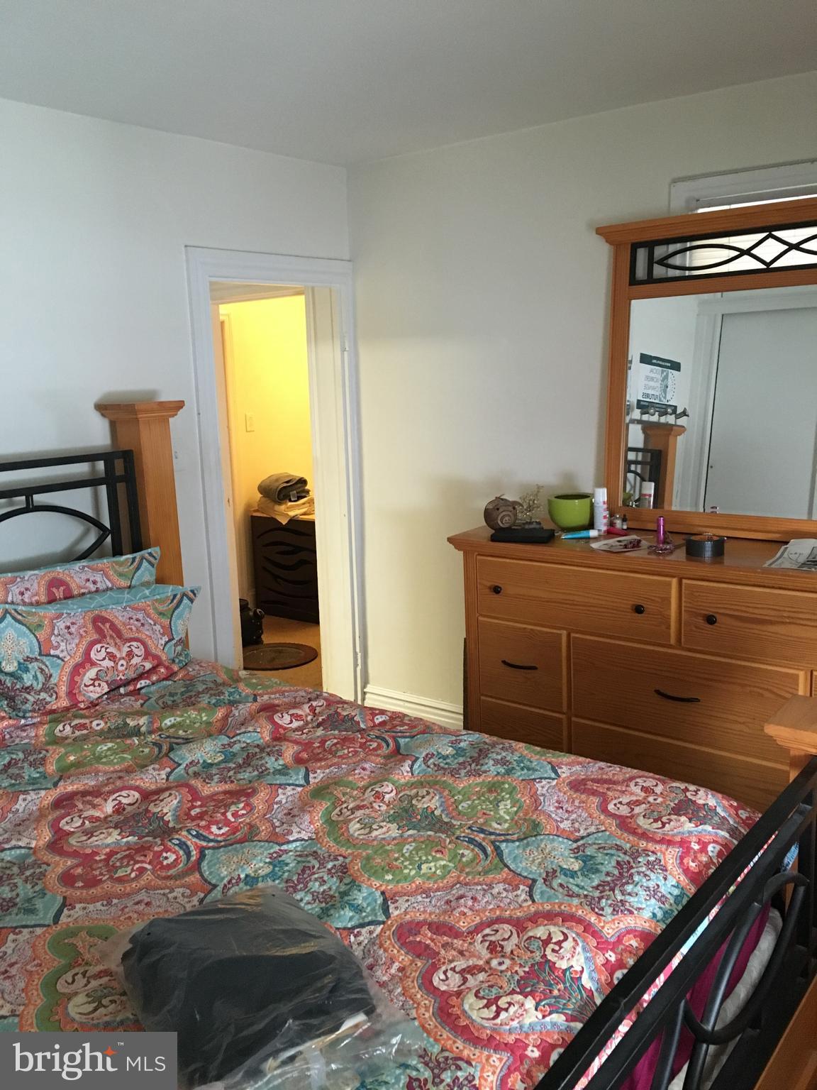 213 Locust Street Hanover, PA 17331 - Photo 4 of 9 a bedroom with a bed and a dresser