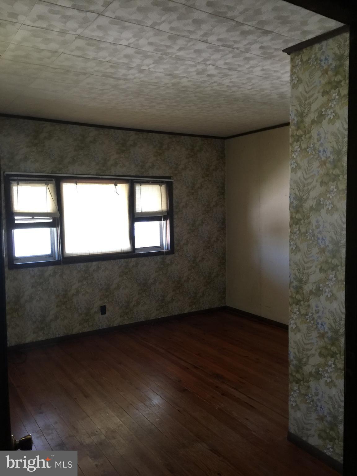 213 Locust Street Hanover, PA 17331 - Photo 7 of 9 a view of an empty room with wooden floor and a window