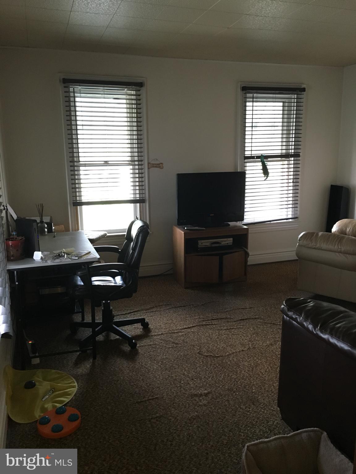 213 Locust Street Hanover, PA 17331 - Photo 8 of 9 a living room with furniture a flat screen tv and a window