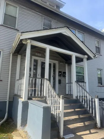 a view of a house with deck and wooden floor
