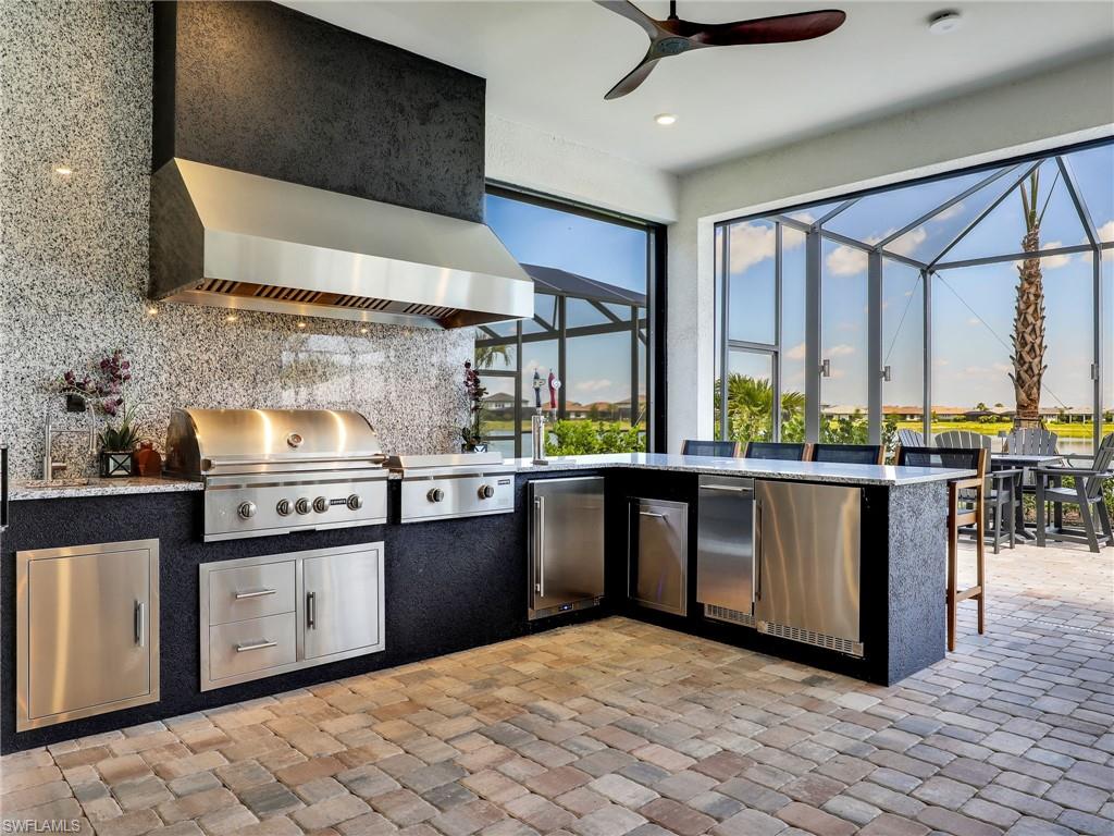 18412 Ridgeline Drive Estero, FL 33928 - Photo 20 of 50 a kitchen with stainless steel appliances granite countertop a stove a sink and a refrigerator