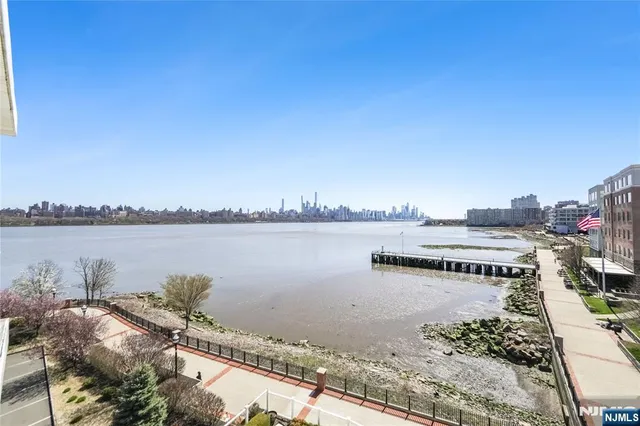 a view of a lake with houses in the back