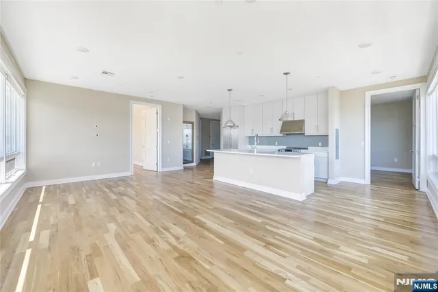 a view of a kitchen with wooden floor