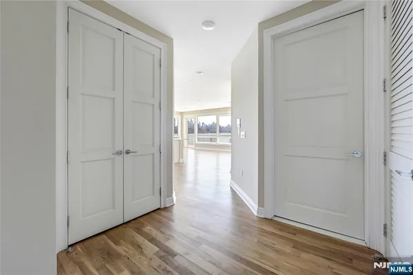 a view of a hallway with wooden floor