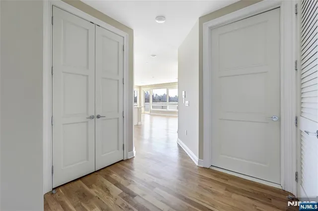 a view of a hallway with wooden floor