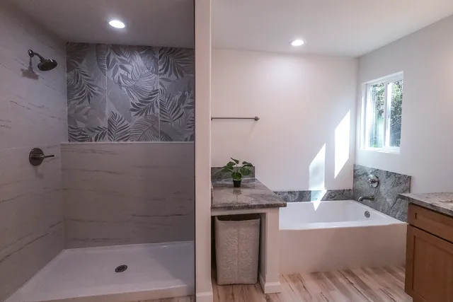 a bathroom with a bathtub and a shower
