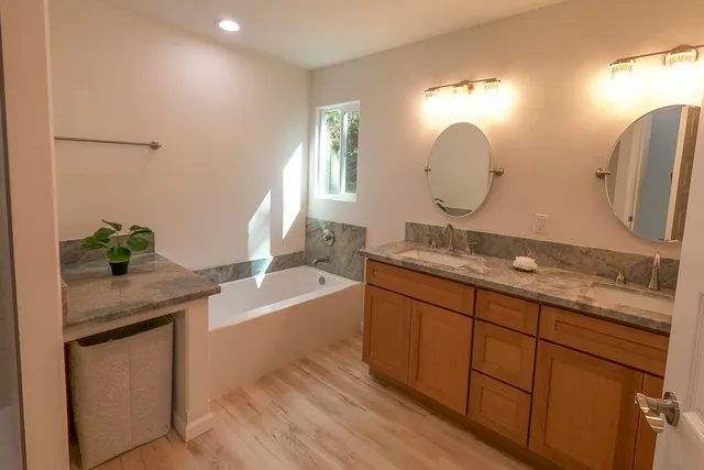 a bathroom with a granite countertop sink a toilet and a mirror