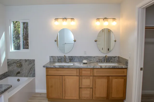 a bathroom with a double vanity sink and a mirror