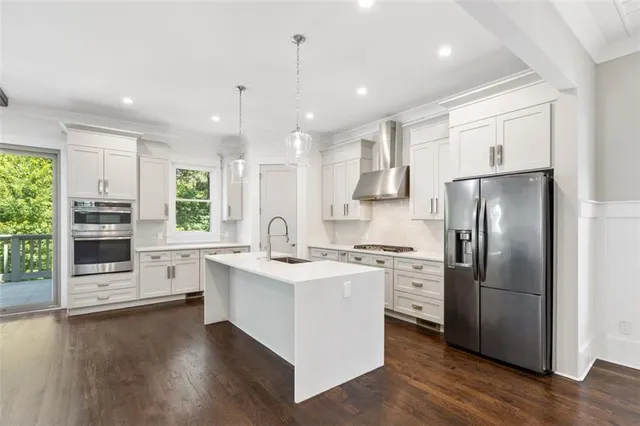 a stove top oven sitting inside of a kitchen