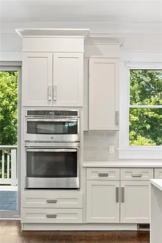 a kitchen with stainless steel appliances granite countertop a sink stove and cabinets